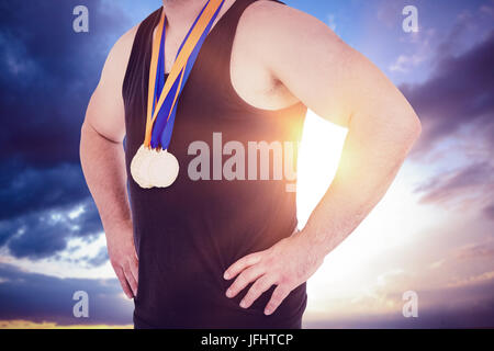 Composite image of close-up of athlete with olympic medal Stock Photo