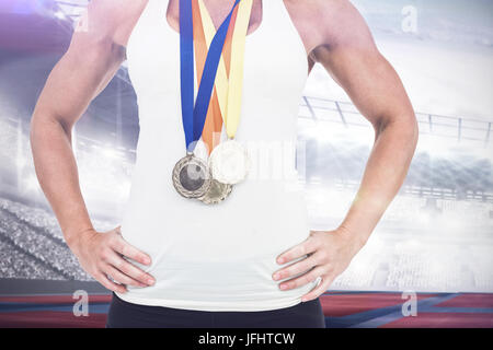 Composite image of female athlete wearing medals Stock Photo