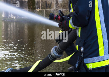 Fire department sprayed extinguishing water during an exercise. Stock Photo