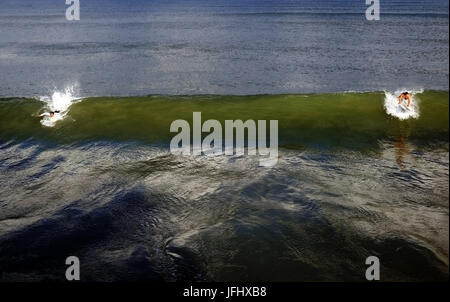 the sea, deep green and blue colours, running accross the centre of the image is a large wave about to break, on the left and right of the pictures ar Stock Photo