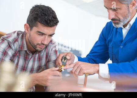 men fixing something Stock Photo