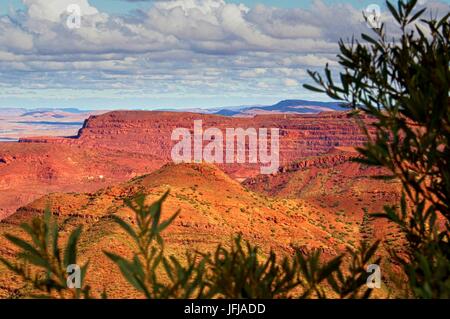 View of Mount Tom Price iron ore mine with wide, cloudy sky above. Stock Photo