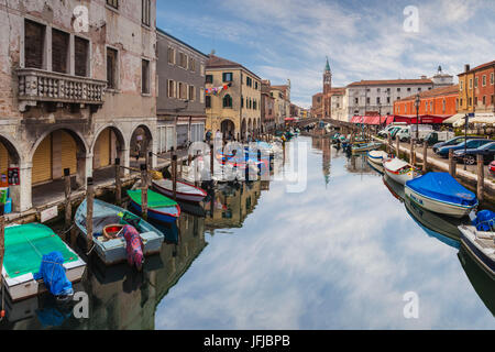 Europe, Italy, Veneto, Venice, A channel with boats moored in Chioggia Stock Photo