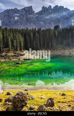 Latemar group reflected in the green waters of Lake Carezza, Ega Valley Dolomites South Tyrol Trentino Alto Adige Italy Stock Photo