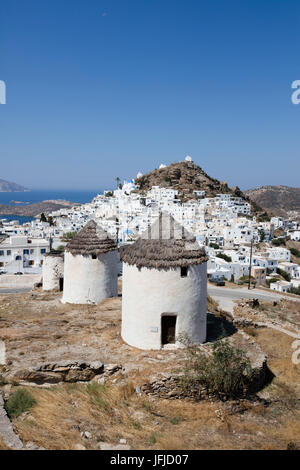 A typical greek village perched on a rock with its white and blue houses and quaint windmills Ios Cyclades Greece Europe Stock Photo