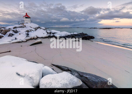 Colorful arctic sunset on the lighthouse surrounded by snow and icy sand Eggum Vestvagoy Island Lofoten Islands Norway Europe Stock Photo