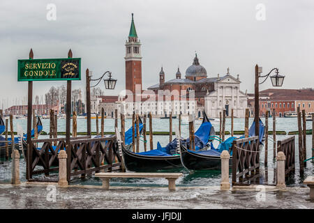 Italy, Veneto, Venice, Gondolas and view of San Giorgio Maggiore Isle from Palazzo Ducale Pier, Stock Photo