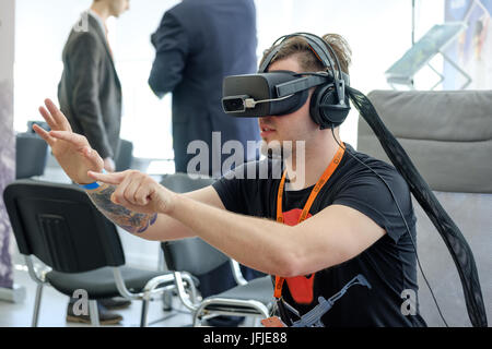 VR conference visitor tests virtual reality helmet Stock Photo