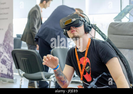 VR conference visitor tests virtual reality helmet Stock Photo