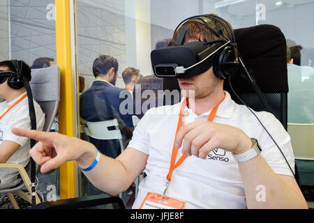 VR conference visitor tests virtual reality helmet Stock Photo