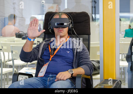 VR conference visitor tests virtual reality helmet Stock Photo