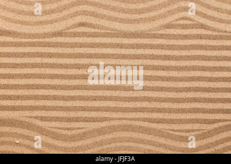 Frame made of zigzag on wavy sand. Texture sand. View from above Stock Photo