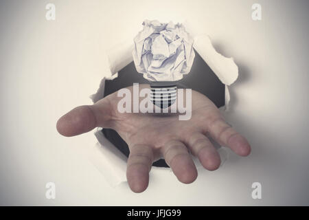 Composite image of hand ripping through paper Stock Photo
