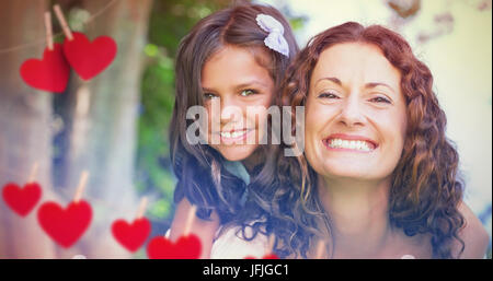 Composite image of  mother and daughter smiling Stock Photo