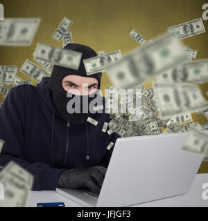 Composite image of hacker in balaclava hacking a laptop Stock Photo