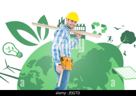 Composite image of smiling worker carrying wooden planks Stock Photo