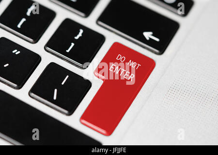 Closeup of laptop computer keyboard with red button and "Do not enter" word on it Stock Photo
