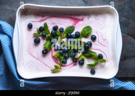 Semifreddo  with blueberry and mint in the ceramic dish on the stone background top view horizontal Stock Photo