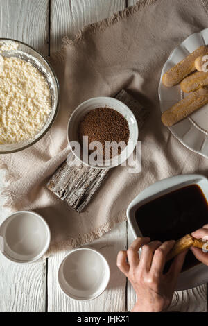 Cooking tiramisu on the white wooden table  top view vertical Stock Photo
