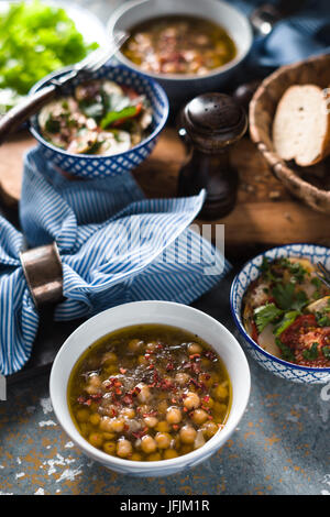 Chickpea soup  Revithia and vegetable stew Briam on the stone background vertical Stock Photo
