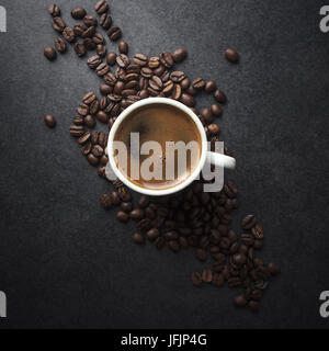 Cup of coffee and beans on table, from above Stock Photo