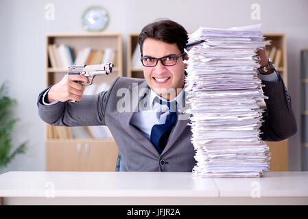 Businessman struggling to meet challenging deadlines Stock Photo
