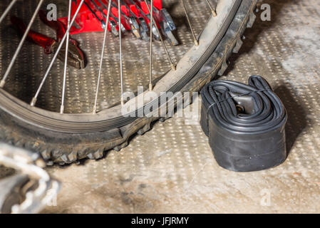 Mountain bike with punctured flat tire. Concept of bad luck and unforeseen Stock Photo