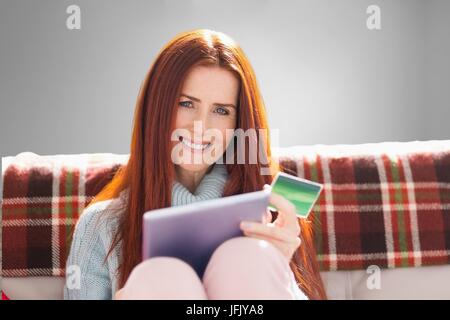 Composite image of woman doing online shopping with her mobile phone ...