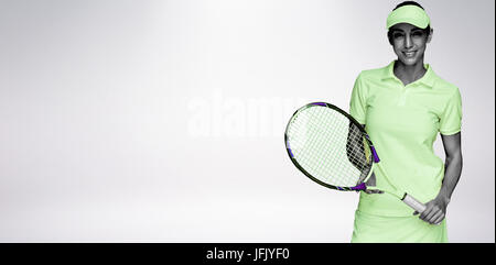 Composite image of female athlete posing with tennis racket Stock Photo