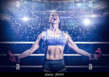 Composite image of winning fighter with arms outstretched Stock Photo