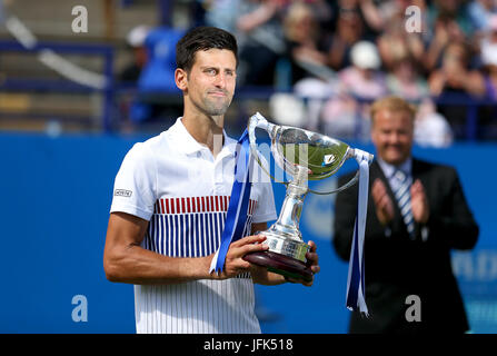 Serbia's Novak Djokovic poses with the trophy after winning the Men's Singles Final against France's Gael Monfils during day nine of the AEGON International at Devonshire Park, Eastbourne. Stock Photo