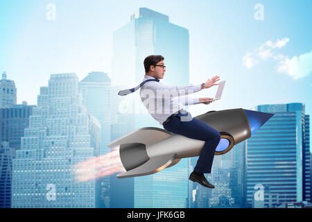 Businessman flying on rocket in business concept Stock Photo