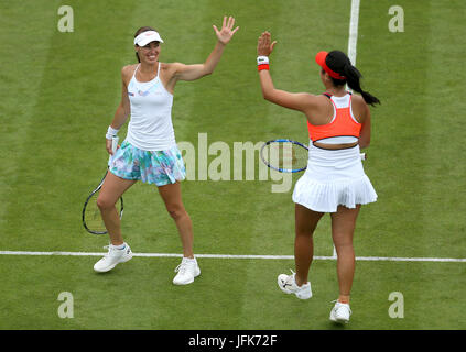 Switzerland's Martina Hingis (left) and Chinese Taipei's Yung-Jan Chan celebrate a point during the Women's Doubles Final against Australia's Ashleigh Barty and Casey Dellacqua during nine of the AEGON International at Devonshire Park, Eastbourne. Stock Photo