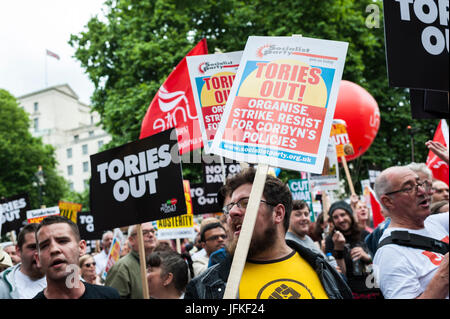 London, UK. 01st July, 2017. Demonstrators carry placards during the 'Not One Day More' march past Piccadilly Circus on July 1, 2017 in London, England. Thousands of protesters joined the anti-Tory demonstration at BBC Broadcasting House and marched to Parliament Square. The demonstrators were calling for an end to the Conservative Government and policies of austerity Credit: onebluelight.com/Alamy Live News Credit: onebluelight.com/Alamy Live News Stock Photo