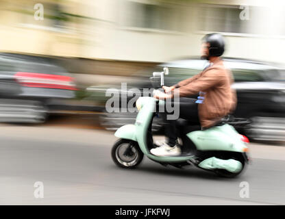 Berlin, Germany. 29th June, 2017. A person drives an electronic scooter from the mobility start up 'Unu' in Berlin, Germany, 29 June 2017. Unu Motors is one of the world's fast rising brand oriented start ups, according a study of brand consulting. They are thus one of the 'Breakthrough Brands'. The Berliners have been producing the electronic scooters since 2014. The start up began expanding into other European countries in 2016 Photo: Jens Kalaene/dpa-Zentralbild/ZB/dpa/Alamy Live News Stock Photo