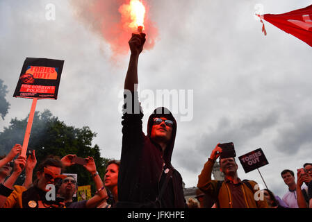 London, UK. 1st Jul, 2017. A protester lights a flare in Parliament Square at the 'Not One Day More' march against the Conservative government. Thousands of protesters marched from Regent Street to Parliament Square, with speechs from Diane Abbott, John McDonnell and Jeremy Corbyn. Credit: Jacob Sacks-Jones/Alamy Live News. Stock Photo