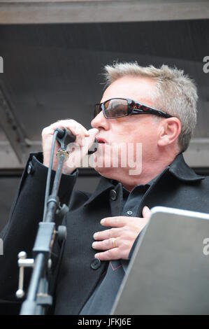 Suggs/Graham McPherson, lead singer, of pop group Madness talks to the Anti-austerity protesters, at John McDonnell's Anti-Tory March in London. Stock Photo