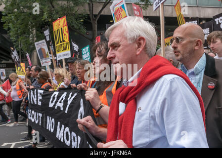 July 1, 2017 - London, UK - London, UK. 1st July 2017. John McDonnell holds the banner at the front of the large march from the BBC to Parliament Square calling for Theresa May and the Conservatives to go. Her snap election failed to deliver a majority and we now have a government propped up the DUP, a deeply bigoted party with links to Loyalist terrorists and bribed to support her. The election showed a rejection of her austerity austerity policies and the Grenfell Tower disaster underlined the toxic effects of Tory failure and privatisation of building regulations and inspection and a total  Stock Photo
