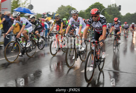 Korschenbroich, Germany. 02nd July, 2017. The peloton passing amidst rain through Korschenbroich, Germany, during the Dusseldorf-Luttich stretch, the 2nd stage of the Tour de France, part of the UCI World Tour, 02 July 2017. Photo: Guido Kirchner/dpa/Alamy Live News Stock Photo