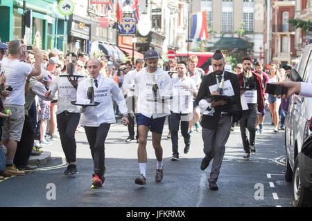 Soho, London. 2nd July, 2017. London restaurant staff sprint around the streets of Soho carrying  a tray in one hand, loaded up with a napkin, half a bottle of champagne and a champagne glass raising funds for new charity The Waiters Benevolent Fund for struggling waiters Credit: amer ghazzal/Alamy Live News Stock Photo