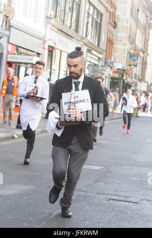 Soho, London. 2nd July, 2017. London restaurant staff sprint around the streets of Soho carrying  a tray in one hand, loaded up with a napkin, half a bottle of champagne and a champagne glass raising funds for new charity The Waiters Benevolent Fund for struggling waiters Credit: amer ghazzal/Alamy Live News Stock Photo