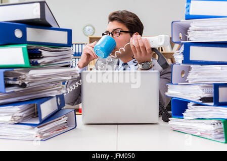 Busy businessman under stress due to excessive work Stock Photo