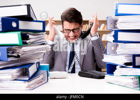 Busy businessman under stress due to excessive work Stock Photo