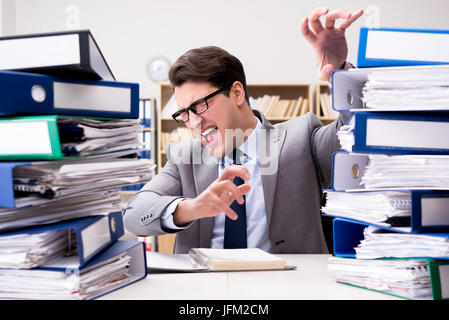 Busy businessman under stress due to excessive work Stock Photo