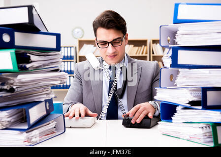 Busy businessman under stress due to excessive work Stock Photo
