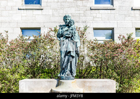 Montreal, Canada - May 28, 2017: St Joseph's Oratory on Mont Royal with statue of the saint holding Jesus Christ in Quebec region city Stock Photo