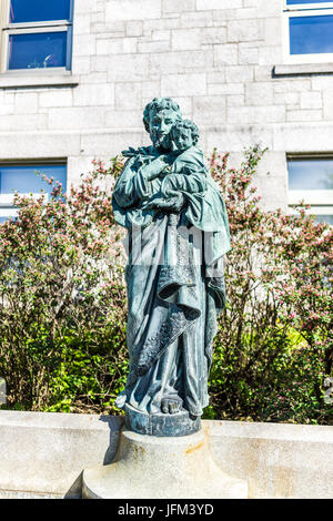 Montreal, Canada - May 28, 2017: St Joseph's Oratory on Mont Royal with statue of the saint holding Jesus Christ in Quebec region city Stock Photo