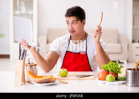 Funny man cook working in the kitchen Stock Photo