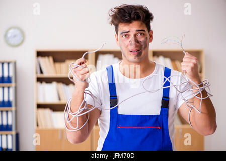 Funny Man doing electrical repairs at home Stock Photo