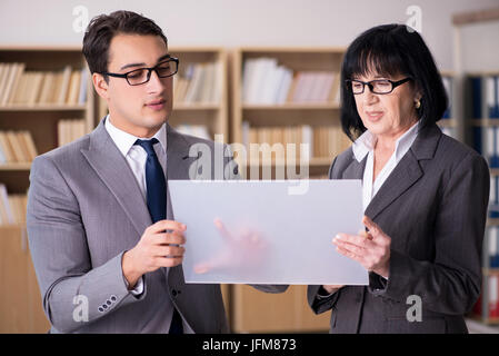 Business couple discussing business results on tablet Stock Photo